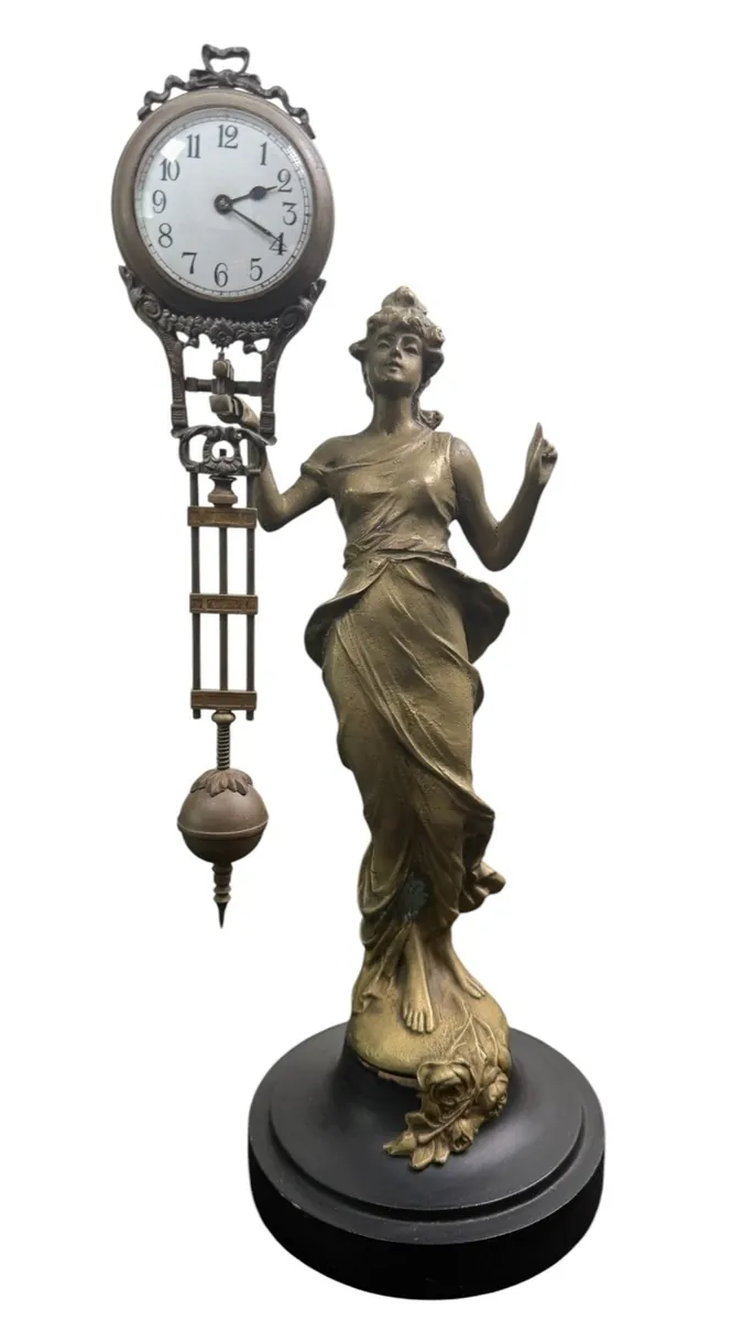 Decorative antique clock sculpture featured in the auction